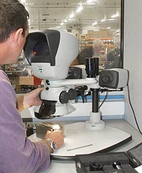 Man using Lynx stereo microscope inspecting spindles containing air bearings