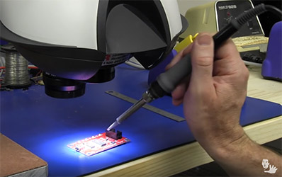 Soldering a PCB under magnification using a Mantis stereo microscope