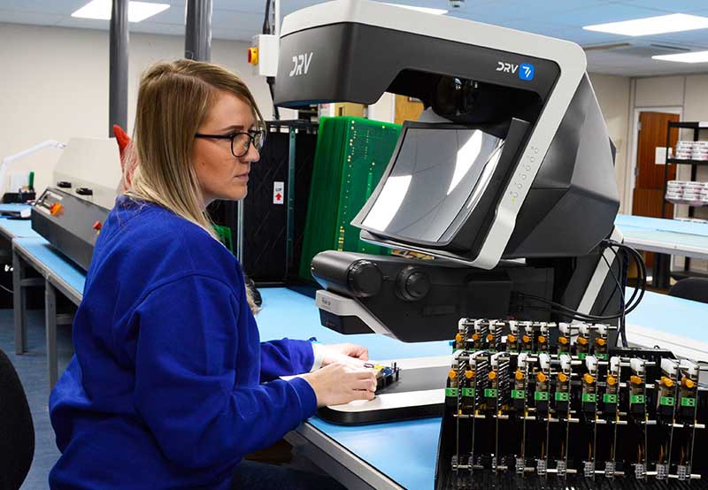 woman inspecting PCBs for quality control using a DRV-Z1 digital viewer