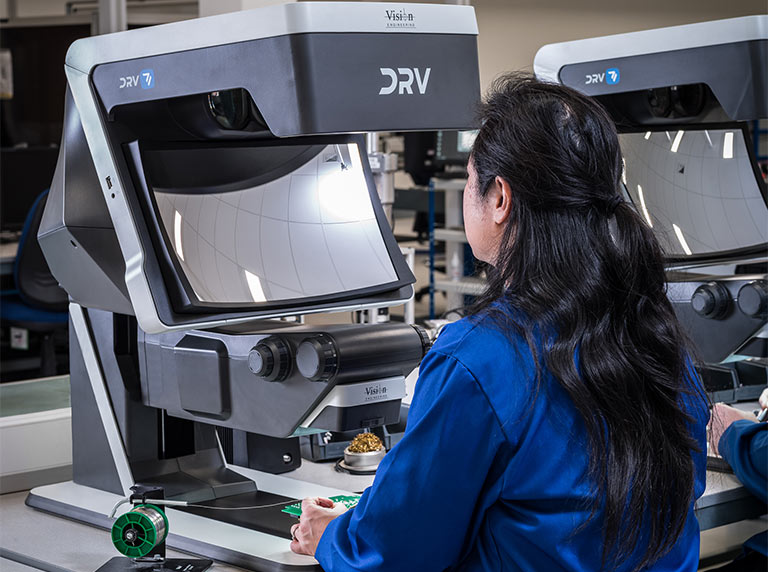 Skeleton using DRV Z1 digital 3D stereo inspection system used by woman in blue coat for soldering application