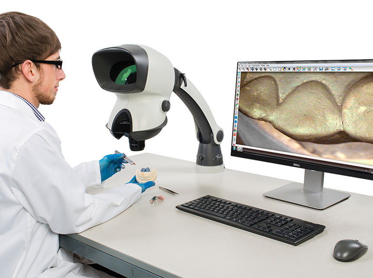 Technician using Mantis stereo microscope for dental application