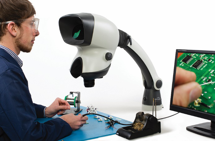 Picture22 Man soldering a PCB viewing with Mantis Stereo Microscope