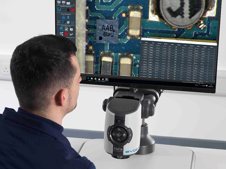 Operator inspecting PCB under magnification using EVO Cam II digital microscope