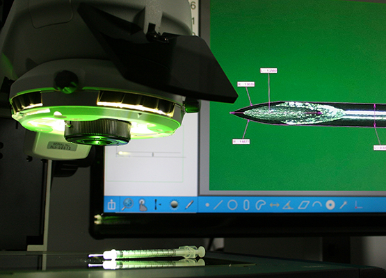 Hypodermic needle inspection under magnification