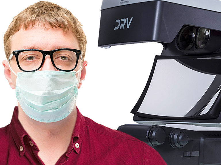 Man in facemask and glasses PPE next to DRV 3D viewer system