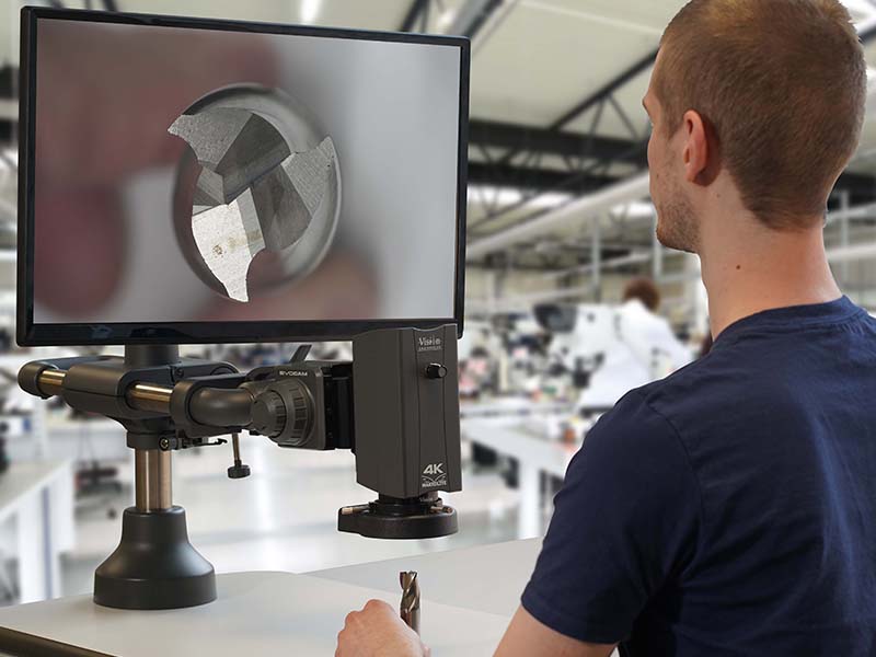 Makrolite 4K digital microscope used by man in factory inspecting turned metal part