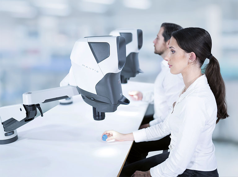 homem e mulher usando estereomicroscópios ergonômicos Mantis
