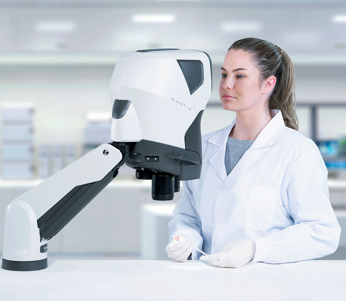 Woman inspecting catheter using Mantis on Verso stand1200x1045 Mantis stereo microscope dental application