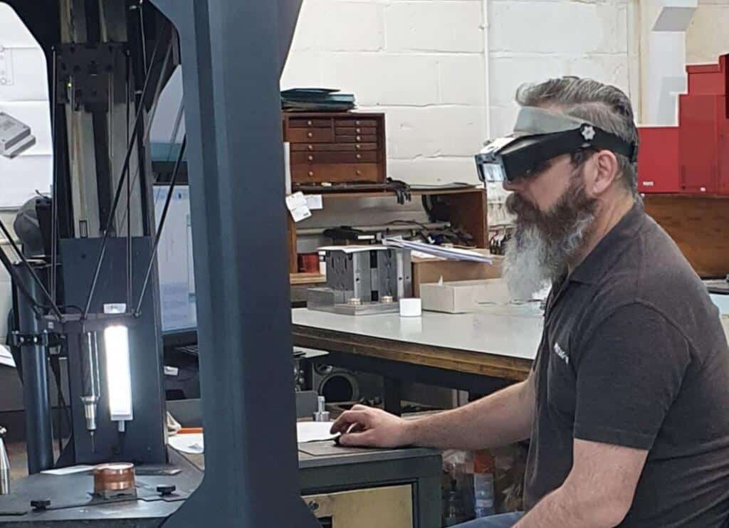 Man from Pentagon Plastics using Deltron CMM to measure a component 