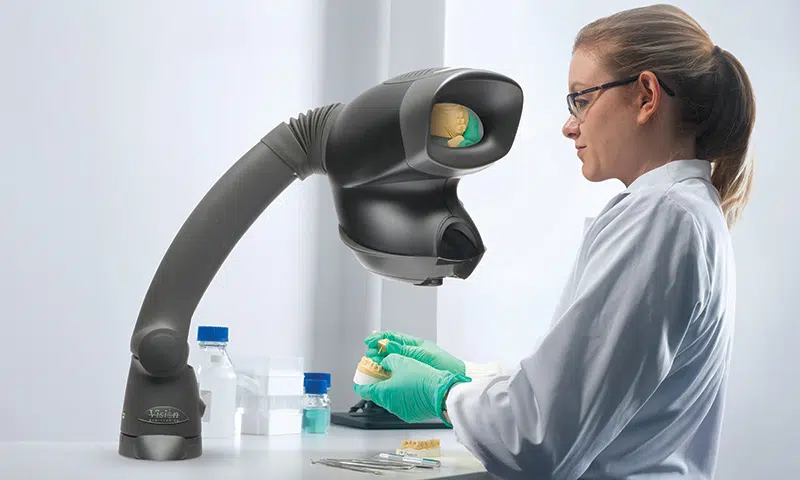 A dental technician using OPTA to inspect a teeth moulding