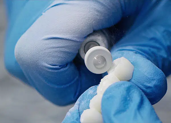Porcelain teeth being worked with a tool